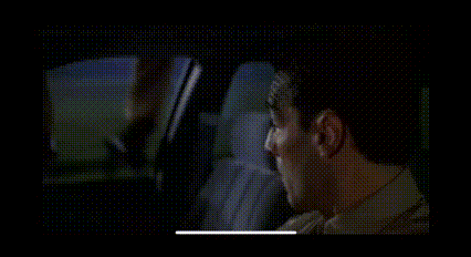 a man is sitting in the back seat of a car .
