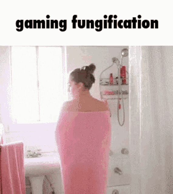 a woman wrapped in a pink towel in a bathroom