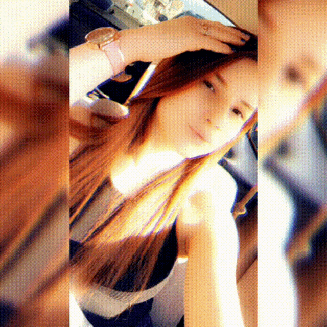 a woman with long red hair is taking a selfie with her hand on her head