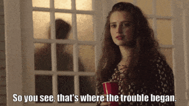 a woman holding a red cup with the words so you see that 's where the trouble began
