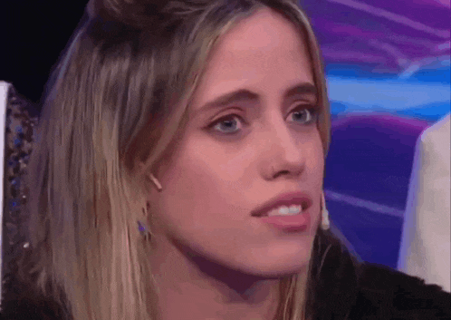 a close up of a woman 's face with a serious look on her face