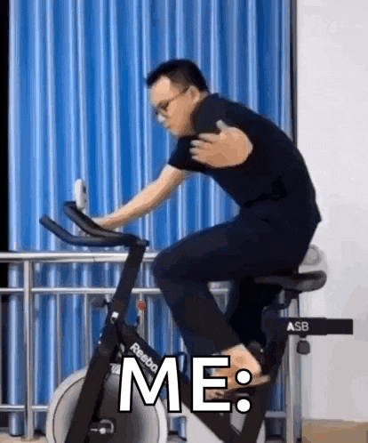 a man is riding an exercise bike and says `` me '' .