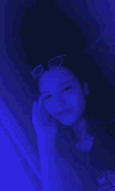 a girl wearing sunglasses and a black shirt that says oh