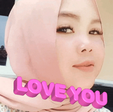 a woman wearing a pink hijab with the words love you written on her face