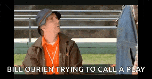 a man is sitting on a bench talking to another man and the words bill obrien trying to call a play are above him .