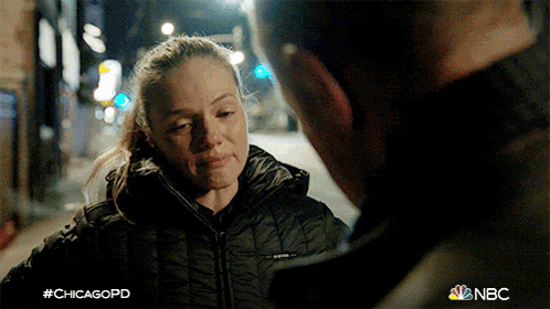 a woman in a black jacket is talking to a man in a black jacket in a scene from chicagopd