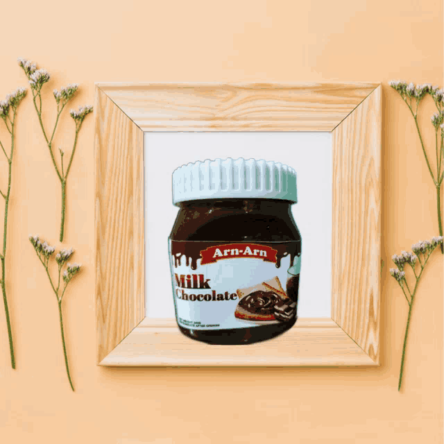 a picture of a jar of arn-arn milk chocolate surrounded by flowers