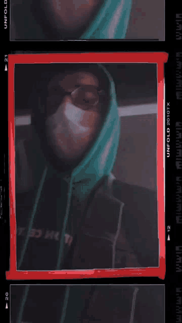 a man wearing a mask is behind a red frame that says unfold