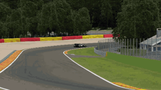 a computer generated image of a race track with a green barrier