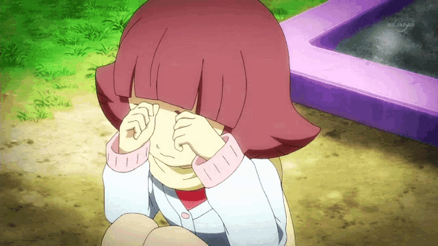 a little girl with pink hair is covering her eyes