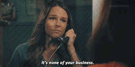 a woman is talking on a telephone and saying `` it 's none of your business . ''
