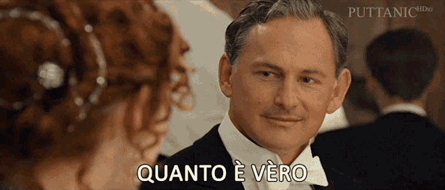 a man in a tuxedo and bow tie says quanto e vero in front of a woman