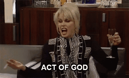 a woman is sitting on a couch holding a glass of wine and yelling at the camera .