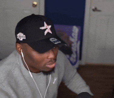 a man wearing a black baseball cap with a star on it