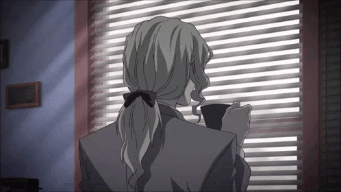 a man with gray hair is looking out a window