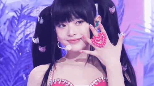 a girl with a heart shaped ring on her hand