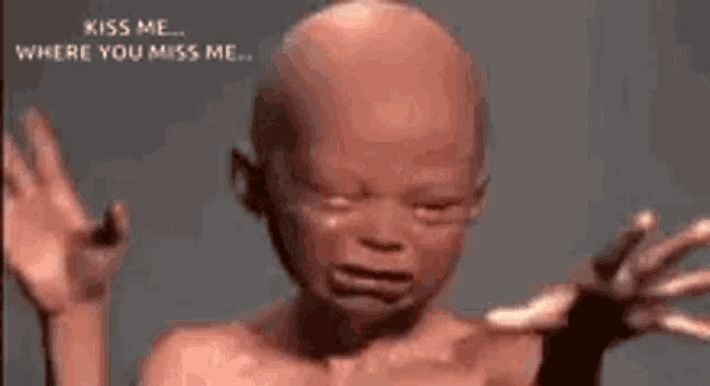 a baby is crying and asking for a kiss .