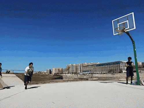 a man wearing a t-shirt that says ' basketball ' on it is playing basketball