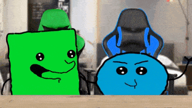 a green and a blue cartoon character are sitting next to each other on a wooden table .
