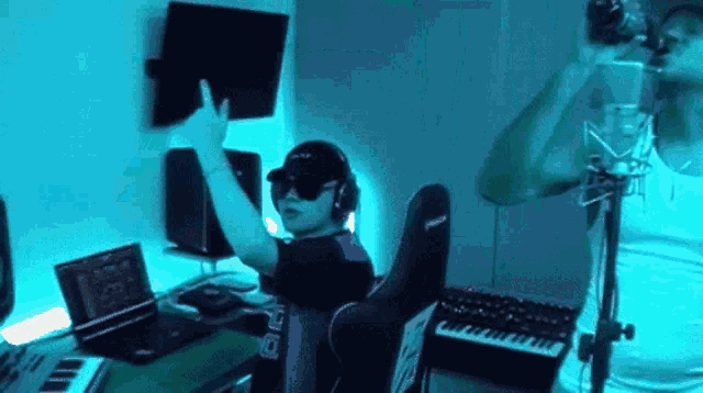 a man is singing into a microphone while wearing headphones