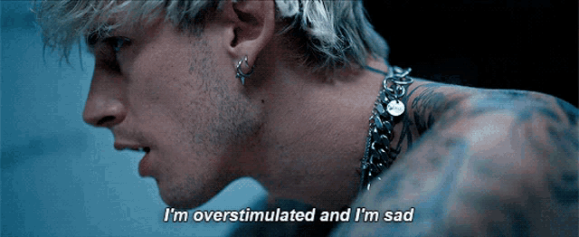 a close up of a man 's face with the words " i 'm overstimulated and i 'm sad "