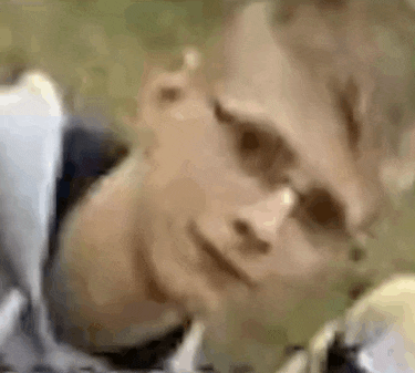 a close up of a person wearing sunglasses making a face .