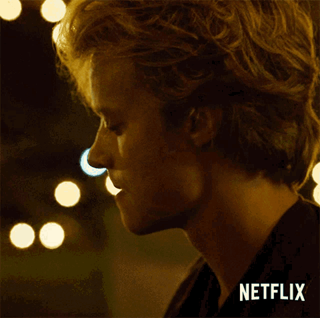 a close up of a man 's face with a netflix logo in the background