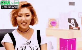 a woman with short hair is wearing a white t-shirt that says crown .