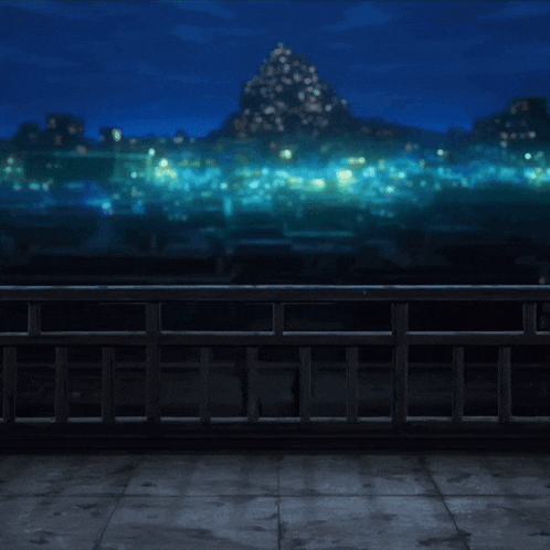 a balcony overlooking a city at night