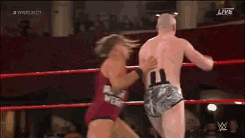 a wrestler with the number 11 on his back is fighting another wrestler in a wrestling ring