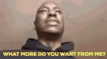 a bald man in a black hoodie is asking what more do you want from me .