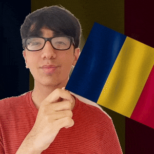 a man wearing glasses is holding a flag in front of him