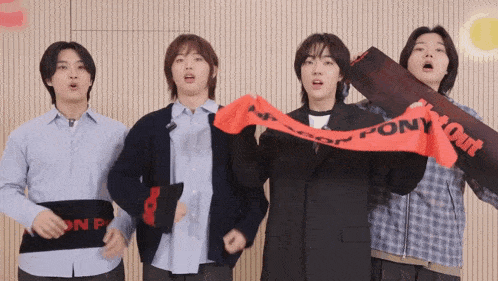 a group of young men are holding up a red scarf that says pony out