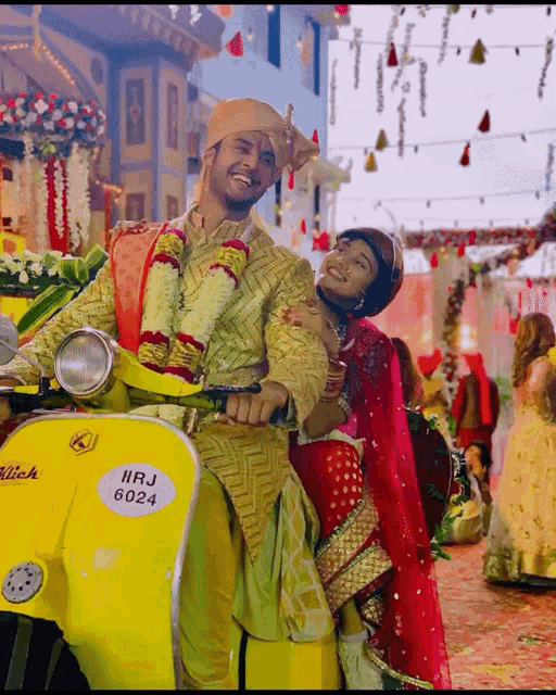 a bride and groom are riding on a yellow scooter with a license plate that says iirj 6024