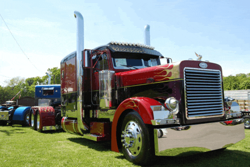 a peterbilt truck with flames painted on the side