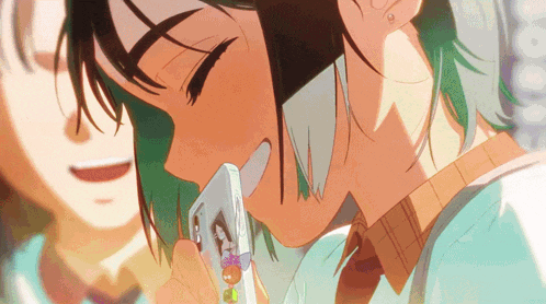a girl with green hair is holding a cell phone in her hand