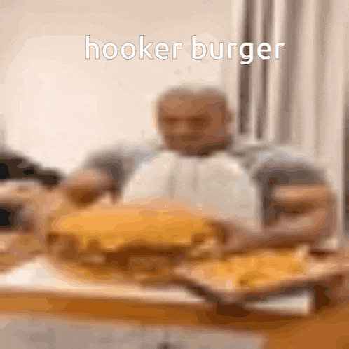 a man is eating a hooker burger with a blurry background