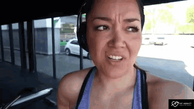 a woman wearing headphones making a funny face