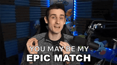 a man is sitting in front of a microphone and saying " you may be my epic match " .