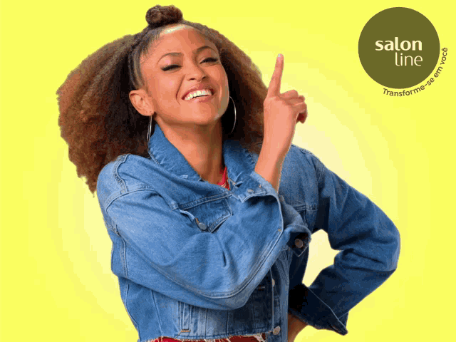a woman in a denim jacket pointing up with a salon line logo in the background