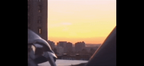 a blurry picture of a city at sunset