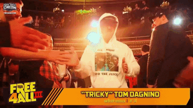 a man wearing a hoodie that says tricky tom dagnino giving a thumbs up
