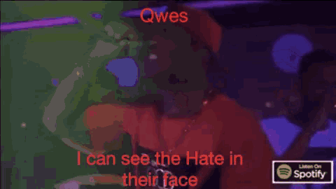 a man singing into a microphone with the words qwes i can see the hate in their face on the bottom