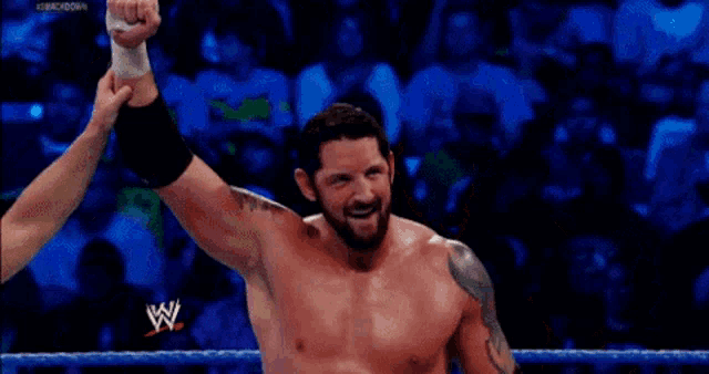 a man in a wrestling ring with a w logo