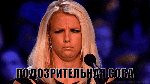 a woman with blonde hair stands in front of a microphone and says " подозрительная сова " on the bottom