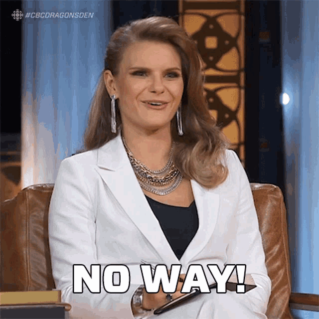 a woman sitting in a chair with the words no way written on her arm