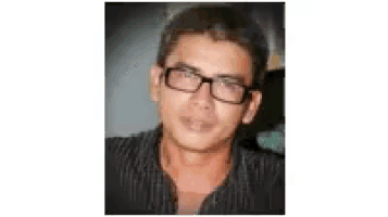 a close up of a man wearing glasses and a black shirt .