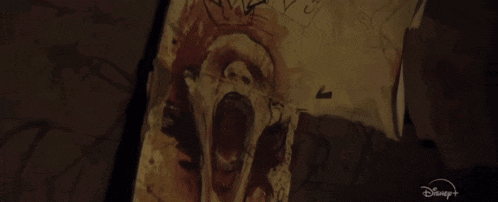 a drawing of a screaming face is on a piece of paper that says disney on it