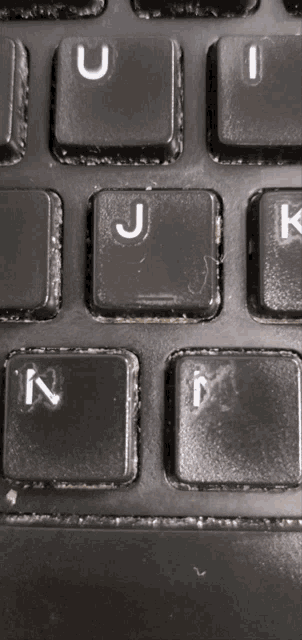 a close up of a keyboard showing the keys u j k and m