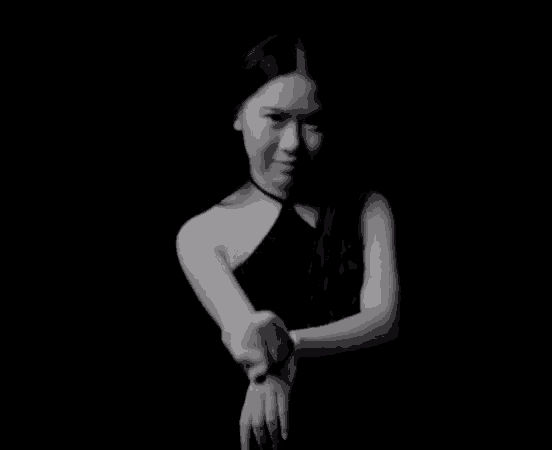 a black and white photo of a woman in a black top